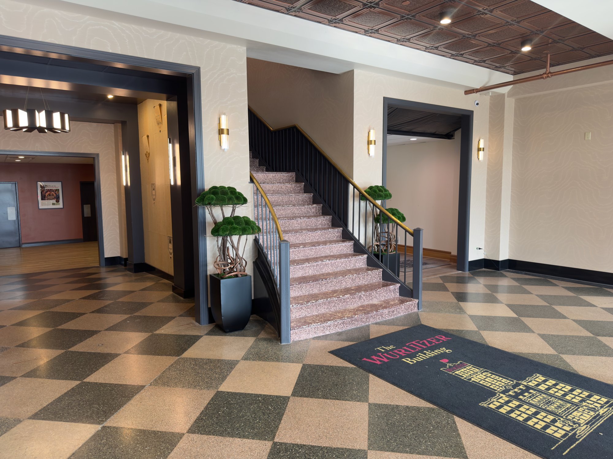 The Wurlitzer lobby with its central staircase, decorative ceiling and patterned floor